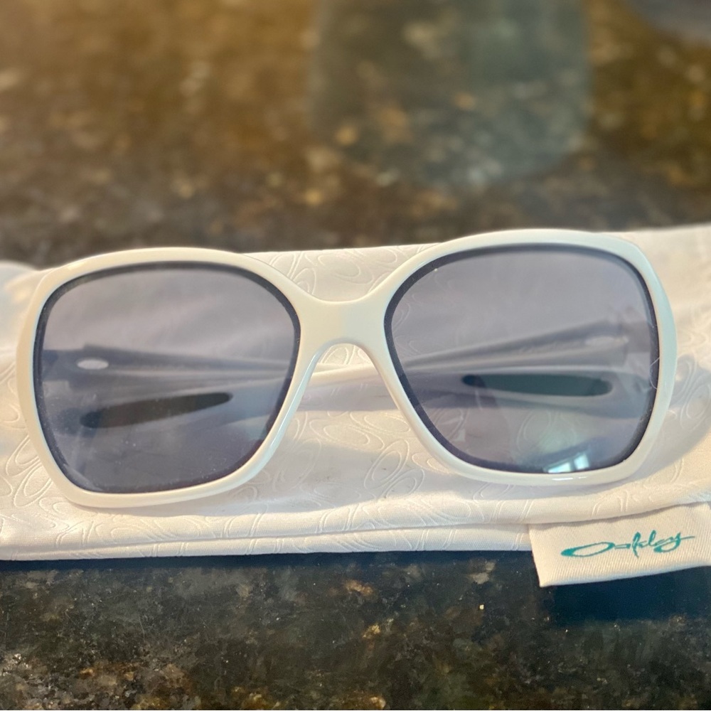 White Oakley sunglasses with white hard case and white sleeve